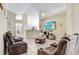 Open living area with hardwood floors, comfortable seating, and kitchen views at 163 Andalusia Loop, Davenport, FL 33837