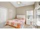 Bright bedroom with a queen bed and bedside table at 163 Andalusia Loop, Davenport, FL 33837