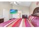 Main bedroom with large bed, mounted TV, and ensuite bathroom access at 163 Andalusia Loop, Davenport, FL 33837