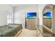 Spacious bedroom with a dresser, TV, and large mirror at 163 Andalusia Loop, Davenport, FL 33837