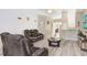 Living room with hardwood floors, comfortable seating, and views into kitchen at 163 Andalusia Loop, Davenport, FL 33837