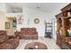 Spacious living room featuring hardwood floors, comfortable seating, and built-in shelving at 163 Andalusia Loop, Davenport, FL 33837