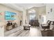 Open living area with hardwood floors, comfortable seating, and large TV at 163 Andalusia Loop, Davenport, FL 33837