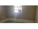 Empty bedroom with a window and neutral walls at 2117 High Point Sw Ave, Winter Haven, FL 33880