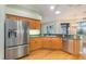 Modern kitchen with stainless steel appliances and wood cabinets at 24429 Madewood Ave, Leesburg, FL 34748