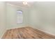 Bright bedroom with light walls, wood-look floors, and a ceiling fan at 24429 Madewood Ave, Leesburg, FL 34748