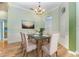 Elegant dining room with glass-top table and hardwood floors at 24429 Madewood Ave, Leesburg, FL 34748