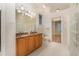 Bathroom with double vanity, granite countertop, and toilet at 24429 Madewood Ave, Leesburg, FL 34748