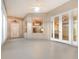 Spacious sunroom with tile floors, French doors, and views of the kitchen at 24429 Madewood Ave, Leesburg, FL 34748
