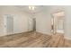 Bedroom with wood-look floors and access to bathroom at 24429 Madewood Ave, Leesburg, FL 34748