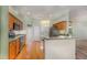 Modern kitchen with stainless steel appliances and wood cabinets at 24429 Madewood Ave, Leesburg, FL 34748