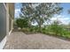 Brick patio and backyard with lush landscaping and trees at 24429 Madewood Ave, Leesburg, FL 34748