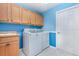 Laundry room with washer, dryer, cabinets, and a sink at 24429 Madewood Ave, Leesburg, FL 34748