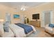 Main bedroom with a large bed, TV, and sitting area at 24429 Madewood Ave, Leesburg, FL 34748