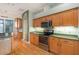 Modern kitchen with stainless steel appliances and wood cabinets at 24429 Madewood Ave, Leesburg, FL 34748