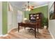 Home office with built-in shelving and hardwood floors at 24429 Madewood Ave, Leesburg, FL 34748