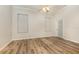 Bright bedroom with wood-look floors and ceiling fan at 24429 Madewood Ave, Leesburg, FL 34748