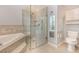 Bathroom with walk-in shower, soaking tub, and toilet at 24429 Madewood Ave, Leesburg, FL 34748