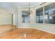 Spacious dining room with hardwood floors and large windows at 24429 Madewood Ave, Leesburg, FL 34748