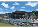 Community pool and clubhouse with lounge chairs and palm trees at 6075 Sacred Oak Ave, Mount Dora, FL 32757