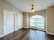 Dining area with hardwood floors and arched window at 7713 Manor Dr, Lakeland, FL 33810