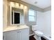 Clean bathroom with white vanity, toilet and shower at 7713 Manor Dr, Lakeland, FL 33810