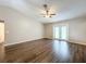 Spacious living room with dark hardwood floors and French doors at 7713 Manor Dr, Lakeland, FL 33810