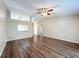 Spacious living room with dark hardwood floors and ceiling fan at 7713 Manor Dr, Lakeland, FL 33810
