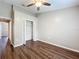 Spacious bedroom with wood-look floors and ceiling fan at 7713 Manor Dr, Lakeland, FL 33810