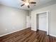 Bright bedroom featuring wood-look floors and ceiling fan at 7713 Manor Dr, Lakeland, FL 33810