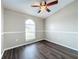 Charming bedroom with arched window and ceiling fan at 7713 Manor Dr, Lakeland, FL 33810