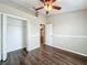 Spacious bedroom with wood-look floors and ceiling fan at 7713 Manor Dr, Lakeland, FL 33810