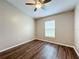 Simple bedroom with hardwood floors and a window with blinds at 7713 Manor Dr, Lakeland, FL 33810