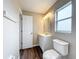 Clean bathroom featuring a vanity, toilet, and updated flooring at 7713 Manor Dr, Lakeland, FL 33810