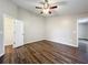 Spacious bedroom with wood-look floors and ceiling fan at 7713 Manor Dr, Lakeland, FL 33810