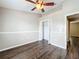Well-lit bedroom, featuring wood-look floors and ceiling fan at 7713 Manor Dr, Lakeland, FL 33810