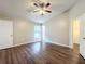 Well-lit bedroom with wood-look floors and ceiling fan at 7713 Manor Dr, Lakeland, FL 33810
