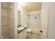 Small bathroom with a bathtub, toilet and wire shelving at 4636 Osceola Point Trl, Kissimmee, FL 34746