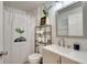 Simple bathroom with white subway tile, gray vanity, and shower/tub combo at 254 Glasgow Ct, Davenport, FL 33897