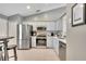 Modern kitchen with stainless steel appliances and white cabinets at 254 Glasgow Ct, Davenport, FL 33897