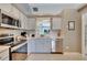 Modern kitchen with stainless steel appliances and light gray cabinets at 254 Glasgow Ct, Davenport, FL 33897