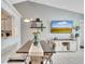 Modern dining area with a large table and flat-screen TV at 254 Glasgow Ct, Davenport, FL 33897