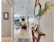 Inviting entryway with a wooden console table and mirror, leading to the living room at 254 Glasgow Ct, Davenport, FL 33897