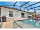 Inviting pool area with a screened enclosure and grill at 254 Glasgow Ct, Davenport, FL 33897