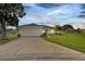 House exterior view at dusk, featuring a garage and well-maintained lawn at 254 Glasgow Ct, Davenport, FL 33897