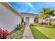 Landscaped front yard with walkway leading to the home's entrance at 254 Glasgow Ct, Davenport, FL 33897
