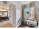 Bright bedroom with wood floors, built-in desk, and access to a full bathroom at 254 Glasgow Ct, Davenport, FL 33897