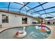 Relaxing pool with inflatable toys and screened enclosure at 254 Glasgow Ct, Davenport, FL 33897
