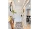 A welcoming entryway with a console table, rug and mirror at 254 Glasgow Ct, Davenport, FL 33897