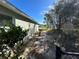 Side yard with grassy area and a section of chain link fence at 1406 Kissimmee Ct, Kissimmee, FL 34759